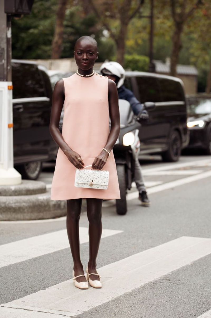 With a Sheath Dress and Statement Handbag